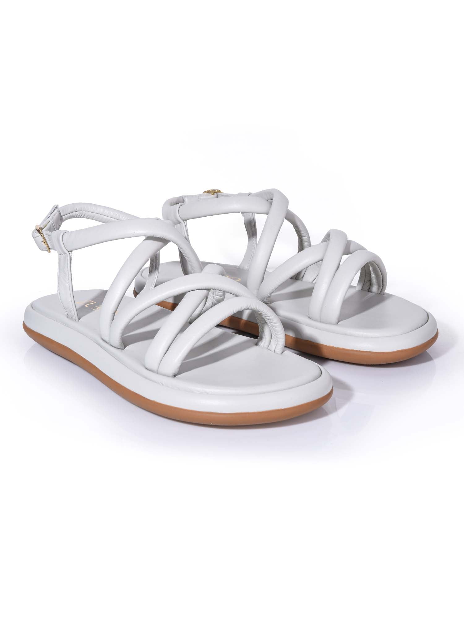 Sandalia plana blanca modelo Nara de Zuoro Shoes, diseño minimalista con tiras acolchadas tipo tubular y hebilla metálica