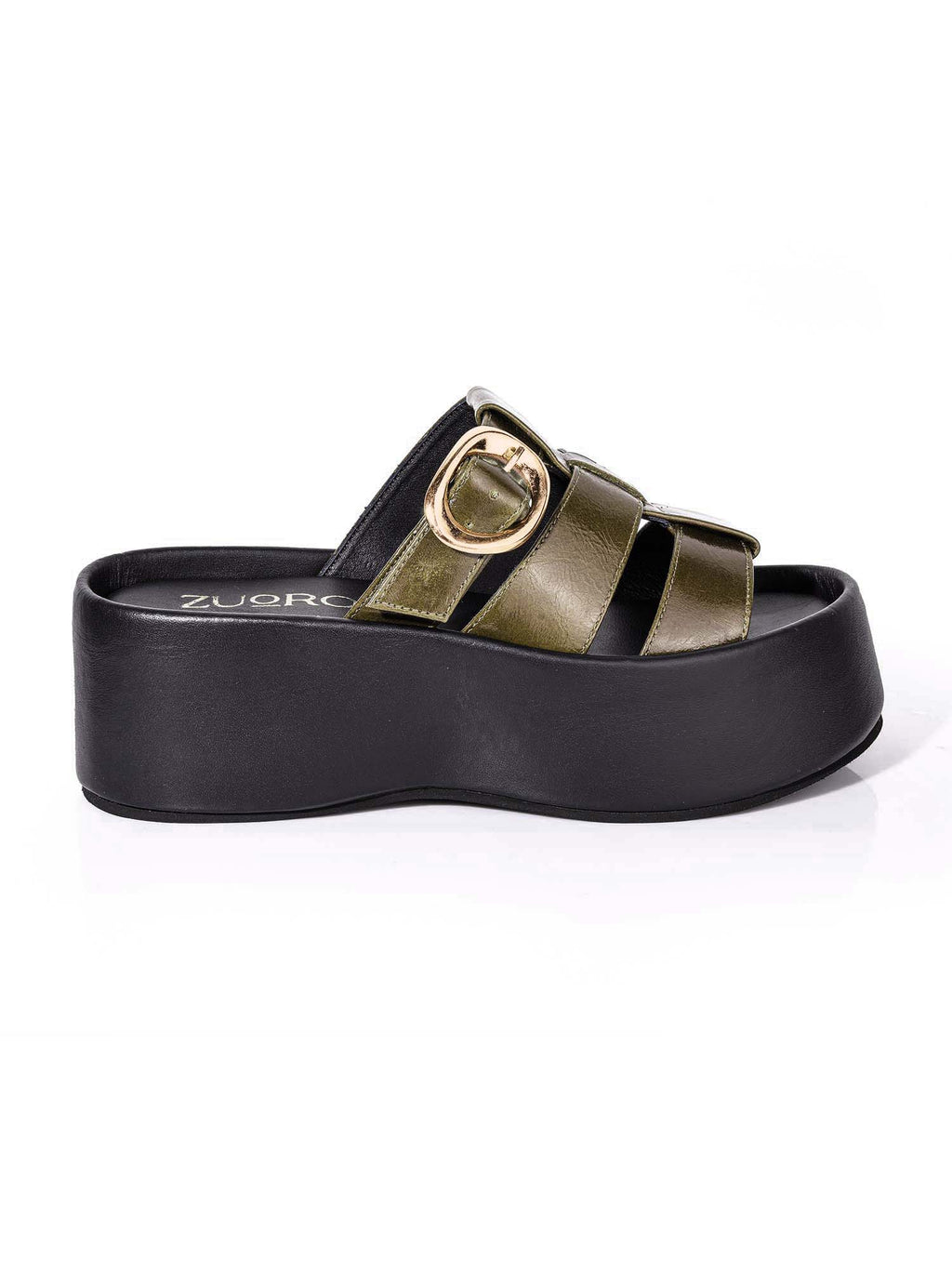 Perfil del modelo Alta de Zuoro Shoes, mostrando la imponente plataforma negra y la estructura envolvente de la capellada verde